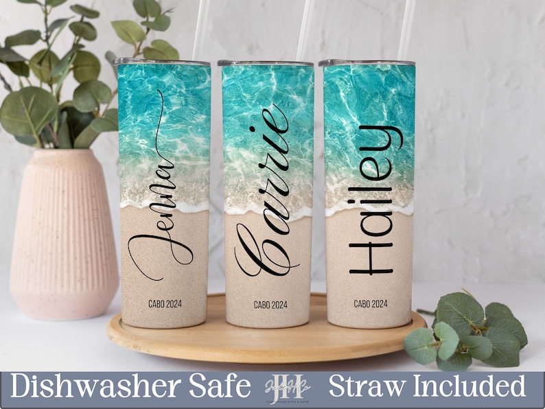Puede incluir: Tres vasos de acero inoxidable personalizados con una escena de playa y los nombres "Jenna", "Barrie" y "Hailey" impresos en ellos. Cada vaso tiene el texto "CABO 2024" impreso en la parte inferior.