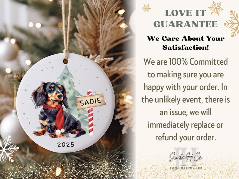 May include: A round ceramic Christmas ornament featuring a dachshund wearing a red scarf, with the name "Sadie" on a sign. The ornament has a Christmas tree and the year 2025. The text "LOVE IT GUARANTEE" is also visible.