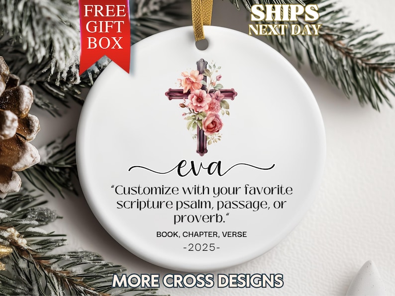 May include: White ceramic ornament with a burgundy cross adorned with pink and peach flowers. The name "eva" is written below the cross, with text that reads "Customize with your favorite scripture psalm, passage, or proverb."
