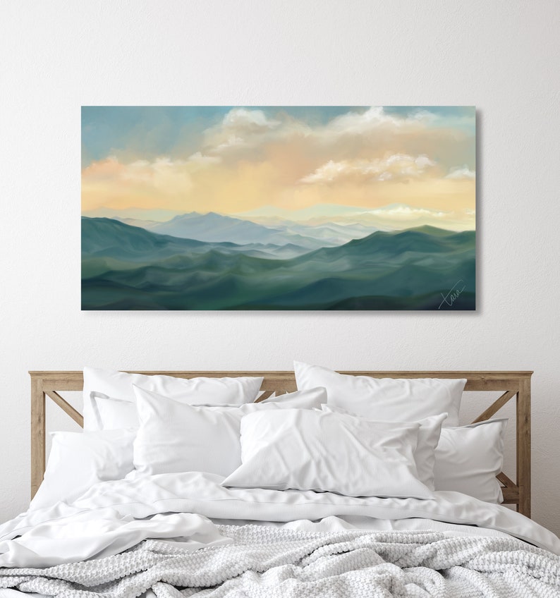 May include: A painting of a mountain range with a soft, hazy blue and green color palette. The sky is a pale yellow with fluffy white clouds. The painting has a calming and serene feel.