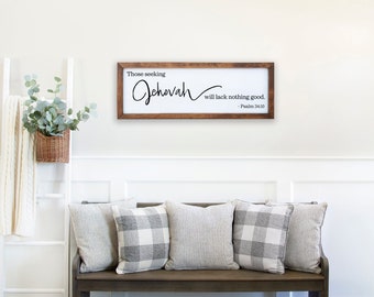 May include: A wooden sign with a brown frame and white background. The sign reads "Those seeking Jehovah will lack nothing good. - Psalm 34:10".