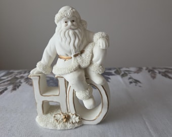 Vintage Santa Claus Sitting on the Letters "HO"
