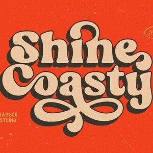 May include: A retro-style font design with the text "Shine Coasty" in a tan color with black outlines. The text is on a red background with a white "NEW" label in a circle.