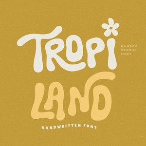 May include: White and yellow handwritten font design with the text "Tropi Land" and a small white flower above the word "Tropi". The text "Hansco Studio Font" is in smaller white text below the word "Tropi" and the text "Handwritten Font" is below the word "Land".