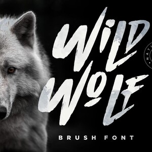 May include: A black and white image of a wolf's face with the text "WILD WOLF" in a white brush font. The text "NATURAL BRUSH FONT" is also included in the image.