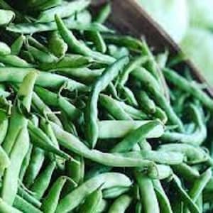 May include: A close-up of a bunch of fresh green string beans. The beans are piled high in a wooden bowl.