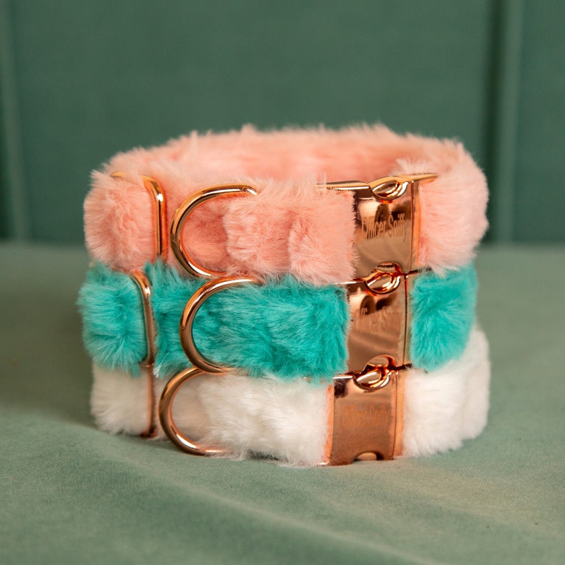 May include: Three layered dog collars in pink, teal, and white faux fur with rose gold hardware.