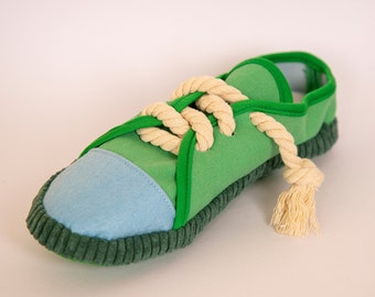 May include: Green and blue fabric toy shoe with a knotted rope tied around it.