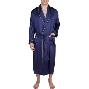 May include: A navy blue satin robe with white piping. The robe has a shawl collar and a tie belt.