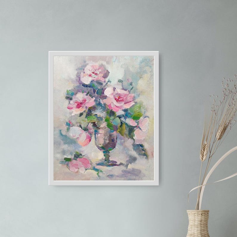 May include: A painting of a bouquet of pink roses in a clear glass vase. The roses are arranged in a loose, natural style, and the vase is set on a table with a white tablecloth. The background is a soft, muted color.
