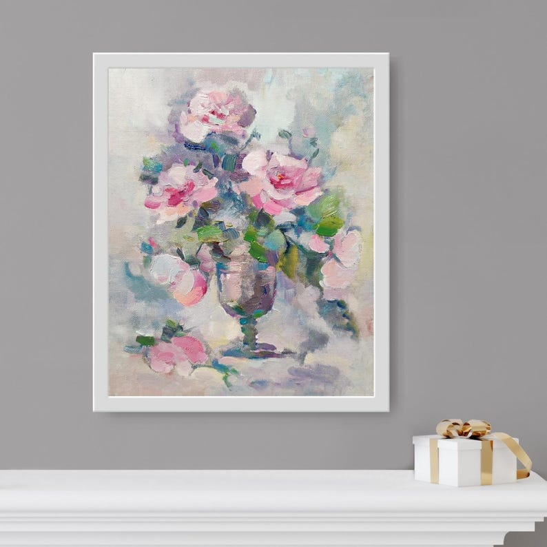 May include: A framed painting of a bouquet of pink roses in a clear glass vase. The roses are arranged in a loose, natural style, and the background is a soft, muted color.