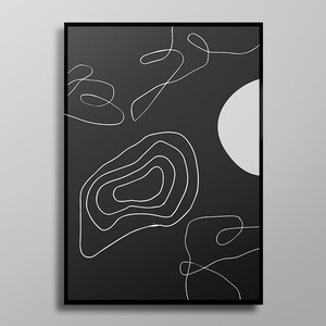 May include: Abstract art print with a black background and white line drawings. The artwork features a large white circle and various freeform lines and shapes. The print is framed in a black border.