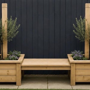 May include: A light brown wooden garden bench featuring two square planters on either side. Each planter includes a tall vertical wooden post and a small green tree with narrow leaves, surrounded by small purple flowers planted in the soil.