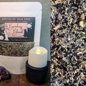 May include: A white bag with black text that reads "REVITALIZE YOUR SOUL RITUALISTIC BATH SOAK SHADOW WITCH Banishing Blend 1-2 BATH SOAKS "See product details on Etsy: RevitalizeYourSoul"  The bag contains a mixture of dried herbs and flowers. A white candle with a black base sits on a wooden surface next to the bag. There are three purple and pink stones on the surface.