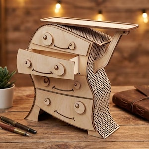 May include: A whimsical wooden dresser with three drawers, each featuring a smiling face design. The dresser has a unique, curved shape and a decorative patterned side. A small shelf is on top. Pens, a journal, and a plant are nearby.
