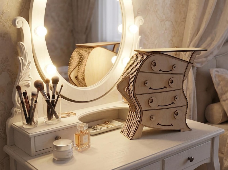 May include: A whimsical wooden dresser with four drawers, featuring a unique, wavy design. The dresser is placed on a white vanity table, next to a lighted vanity mirror and makeup brushes. The overall theme is home decor.