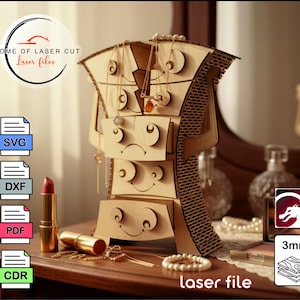 Puede incluir: Un organizador de joyas de madera con múltiples cajones y colgadores de collares. El organizador tiene un diseño único con formas recortadas y un asa decorativa. El texto "laser file" es visible. El organizador se muestra sobre una superficie de madera con joyas y un lápiz labial.