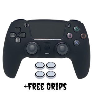 May include: Black gaming controller with directional pad, buttons, and joysticks. Includes four white and silver grip pads. Text at the bottom reads "+ FREE GRIPS".