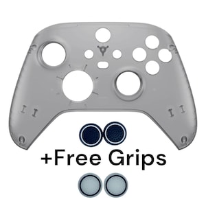 May include: A clear plastic shell for an Xbox controller. The shell is designed to fit over the existing controller and has cutouts for all of the buttons and ports. The shell is shown with two sets of thumbstick grips, one set is black and the other is white. The text " +Free Grips" is shown below the shell.