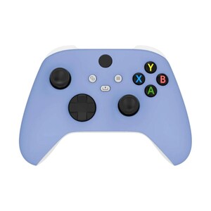 May include: A periwinkle blue video game controller with black buttons and white accents. The controller features a directional pad, two analog sticks, and action buttons in green, red, blue, and yellow. The controller is designed for gaming.