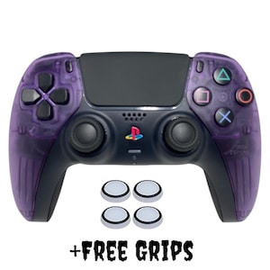 May include: A purple PlayStation 5 DualSense controller with four white thumbstick grips. The controller has a black faceplate and the PlayStation logo is visible. + FREE GRIPS