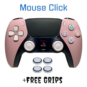 May include: A pink and black PlayStation 5 controller with white buttons and analog sticks. The controller comes with four white grip caps. The text "Mouse Click + FREE GRIPS" is printed below the controller.