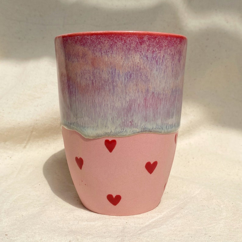 handmadepink porcelain mugwith flow glaze and hand painted red hearts