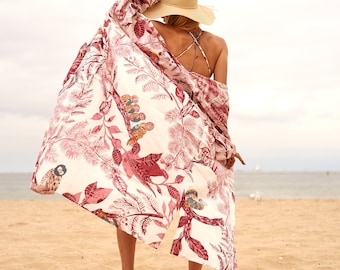 May include: A white and pink floral print kimono with long sleeves and a tie closure. The kimono has a red and white floral pattern with birds and leaves.