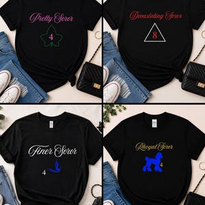 May include: Four black short-sleeve t-shirts featuring graphic prints. The first displays 'Pretty Soror' with an ivy leaf and the number 4. The second shows 'Devastating Soror' with a triangle and 8. The third says 'Finer Soror' with a blue bird and 4. The fourth reads 'Rhoyal Soror' with a blue poodle and 4.