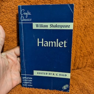 May include: A paperback copy of Hamlet by William Shakespeare, part of the Crofts Classics series. The cover is dark blue with light yellow horizontal bands featuring the title, author, editor R. C. Bald, and publisher Appleton-Century-Crofts.