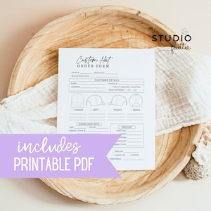May include: A white "Custom Hat Order Form" with fillable fields for customer details and hat specifications. The form includes hat diagrams and the text "includes PRINTABLE PDF". The form is on a wooden tray with a white cloth.