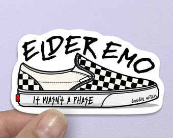 May include: A sticker featuring a black and white checkered slip-on shoe design. The text "ELDER EMO" is above the shoe, with "IT WASN'T A PHASE" below. The artist's signature, "doodle witch," is on the side.