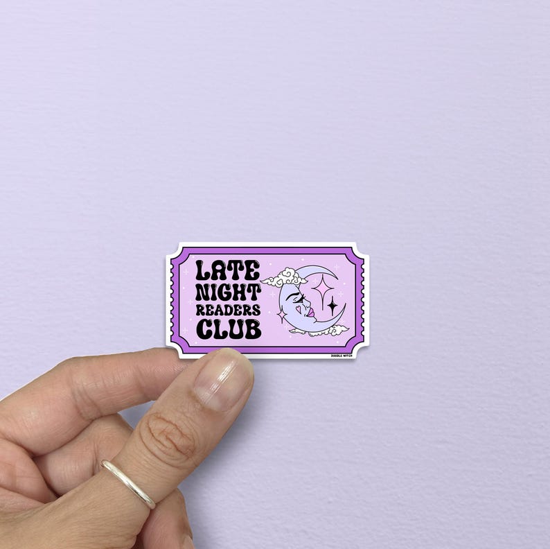 May include: A sticker with a purple border and the words "LATE NIGHT READERS CLUB" in black and white. The sticker features a crescent moon with a face, stars, and clouds.