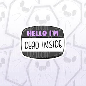 May include: A black sticker with the text "HELLO I'M DEAD INSIDE" in white and purple. The sticker has a rounded rectangle shape with a white border. The background features a pattern of cartoon ghosts.