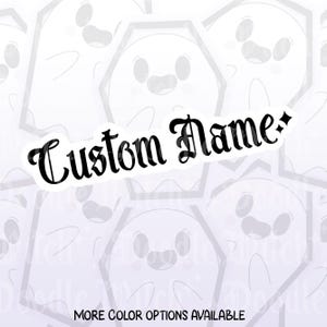 May include: A white sticker with a black outline of a smiling ghost in a coffin shape. The words "Custom Name" are written in a decorative black font. The text "MORE COLOR OPTIONS AVAILABLE" is at the bottom.