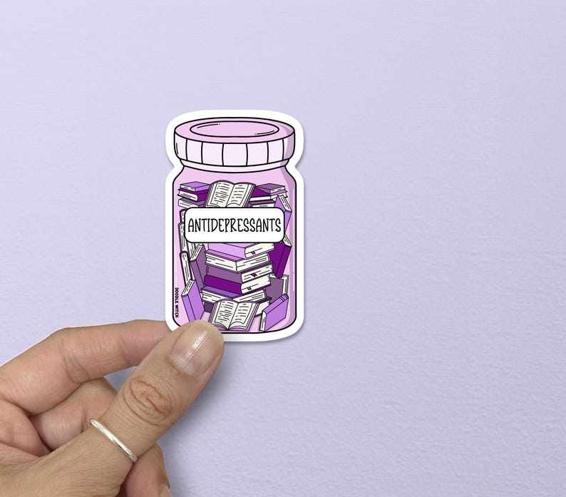 May include: A sticker featuring a purple jar labeled "ANTIDEPRESSANTS" filled with stacks of purple books and open books. The jar has a pink lid and is held by a hand against a light purple background.