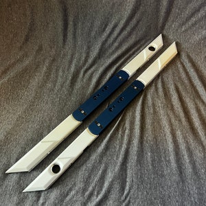May include: Two long, white metal rods with a dark blue stripe down the centre. The rods have a rounded end and a pointed end. The rods have several small holes along the length.