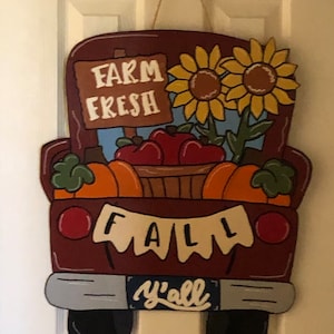 Herfstwagendeurhanger met pompoenen, appels en zonnebloemen