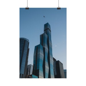 May include: A tall, modern skyscraper with a unique, wavy design stands out against a clear blue sky. A small airplane flies overhead.
