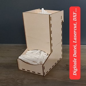 May include: A wooden organizer for holding small items, such as screws or nails. The organizer has a slot for dispensing the items and a compartment for storing them. The organizer is made of light brown wood and has a simple design.