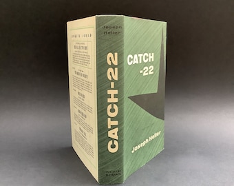 Vintage hardback copy of Catch-22 by US writer Joseph Heller from The Reprint Society in 1963 with a great cover design.