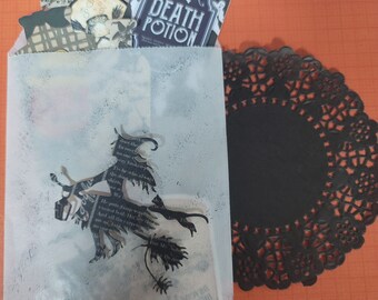 May include: A Halloween-themed paper bag with decorative cutouts and embellishments. The bag features a witch silhouette, and the words "Death Potion" on a bottle-shaped cutout. A black paper doily sits on an orange background.