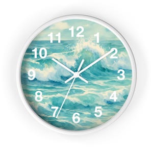 May include: A white-framed wall clock featuring a watercolor painting of ocean waves in shades of blue and white. The clock face displays white numerals and hands, creating a coastal theme. The clock's design evokes a sense of the sea.