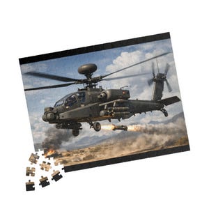 May include: A military-themed jigsaw puzzle depicting a dark green Apache helicopter in flight, with weapons firing and explosions in the background. The puzzle is partially assembled, with some pieces scattered around the edges.