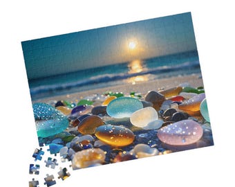 May include: A jigsaw puzzle featuring a beach scene with colorful sea glass and pebbles. The background shows a sunset over the ocean. The puzzle pieces are visible at the bottom.