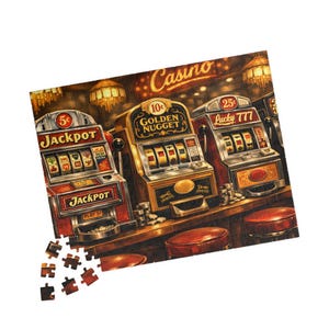 May include: A jigsaw puzzle featuring a vintage casino scene. The image shows three slot machines with the text "Jackpot", "Golden Nugget", and "Lucky 777". The puzzle pieces are scattered at the bottom, with a bar and stools in the foreground.