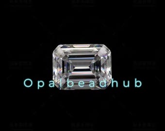 May include: A clear, emerald-cut gemstone with a brilliant, faceted design. The gemstone is set against a black background.