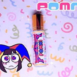 May include: A perfume bottle with a gold cap and a colourful label featuring the word "POMNI". The label has a pink and blue design with the word "POMNI" repeated. The background is a light pink with colourful doodles and a cartoon character.