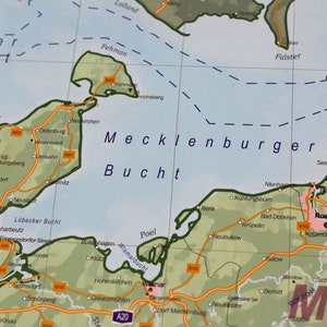 May include: A map of the Mecklenburg Bay, a body of water in northern Germany. The map shows the coastline, major cities, and towns, including Rostock, Wismar, and L&uuml;beck. The map also shows the names of the surrounding bodies of water, including the Baltic Sea, the Kieler Bucht, and the Lubecker Bucht.