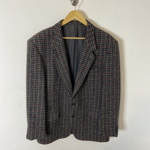 May include: A brown, black and red plaid blazer with a single button fastening.